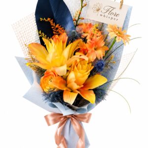 Autumn Radiance golden lily bouquet with blue thistle accents and pale blue wrapping on a white background